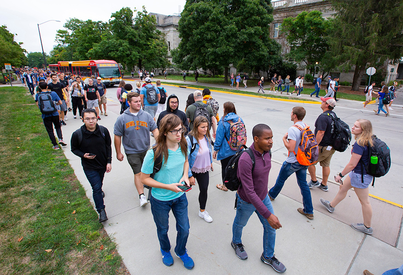 Students walking to class on campus sidewalks