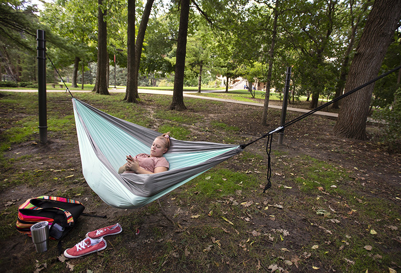 Freshman Autumn Gannon relaxing in her hammock on campus.