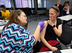 Female employee receives flu shot