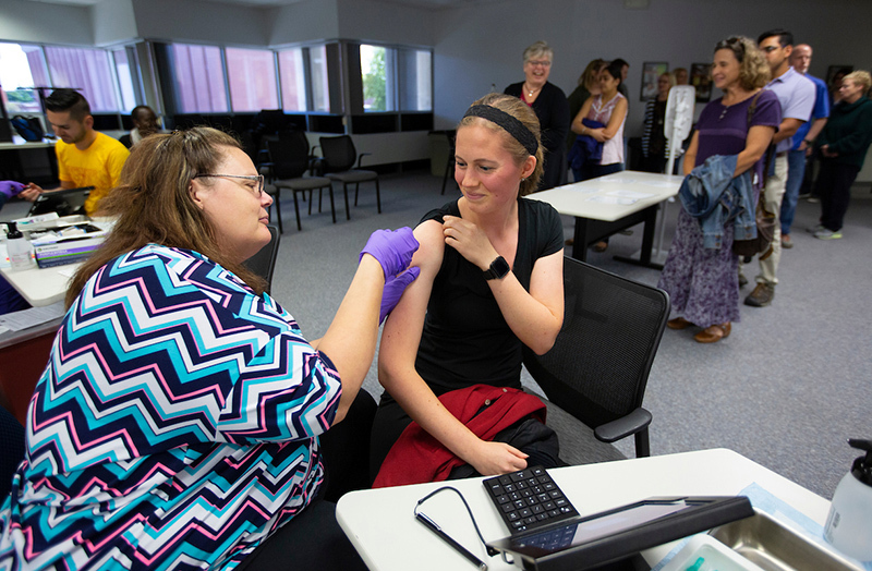 Female employee receives flu shot