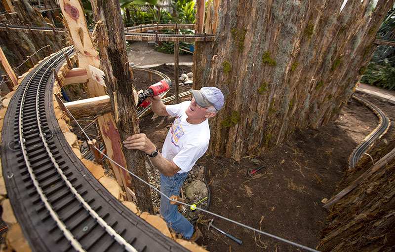 Volunteer Carroll Marty helps set up the train exhibit