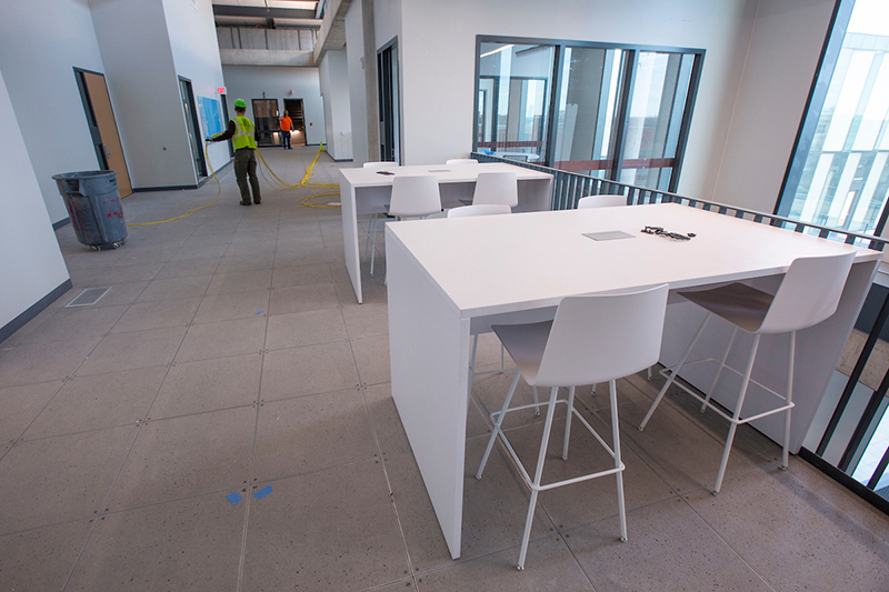 Fourth-floor interaction space with high tables and chairs