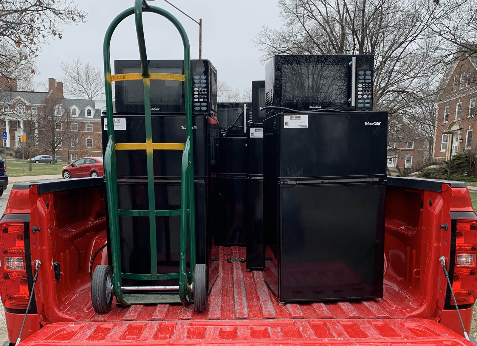 MicroFridges being unloaded from a pickup.