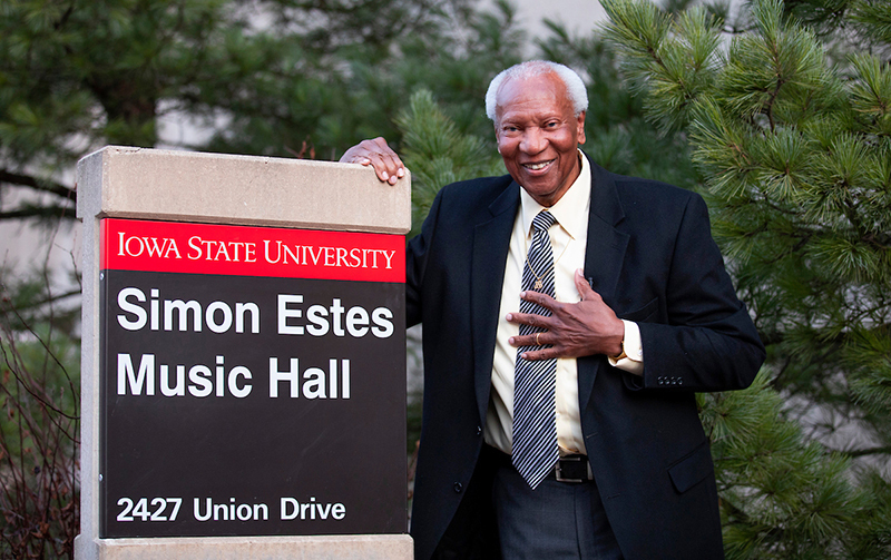 Simon Estes next to the new Music Hall sign bearing his name