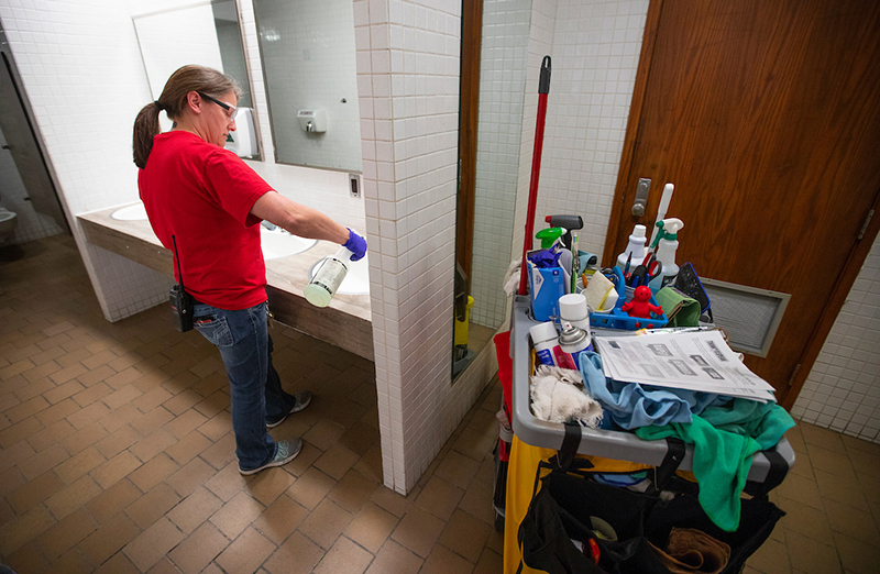 Darcie Buerer cleans a residence hall restroom