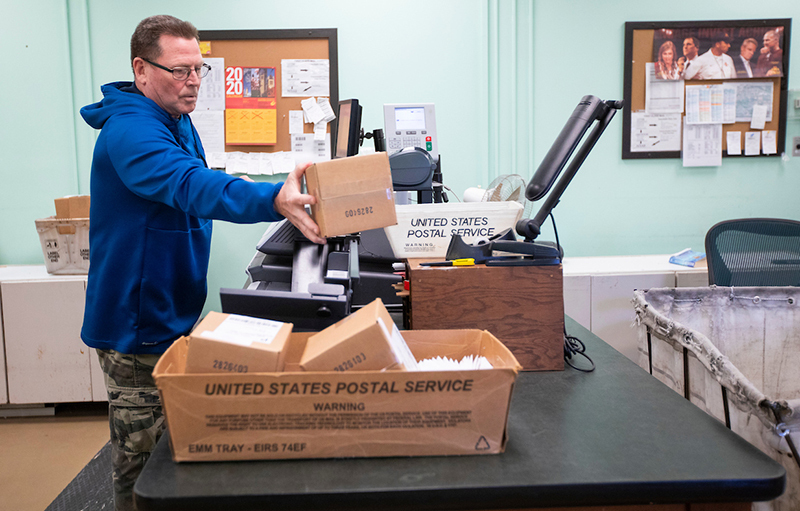 Mail clerk Jon Wing sorts parcels