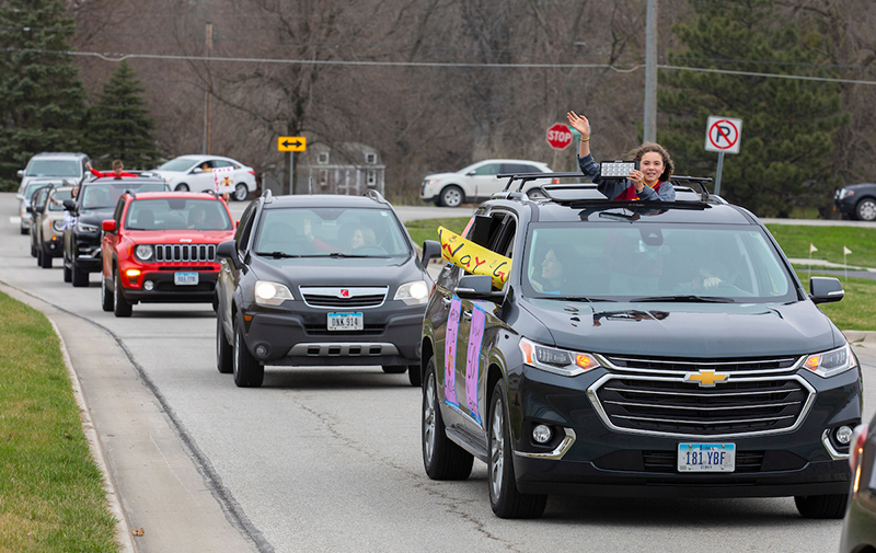 Admissions employees drive past Faye Draper's home