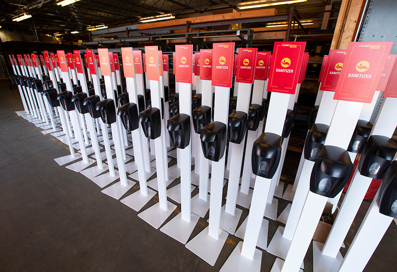 Hand sanitizer dispensers stand ready for distribution