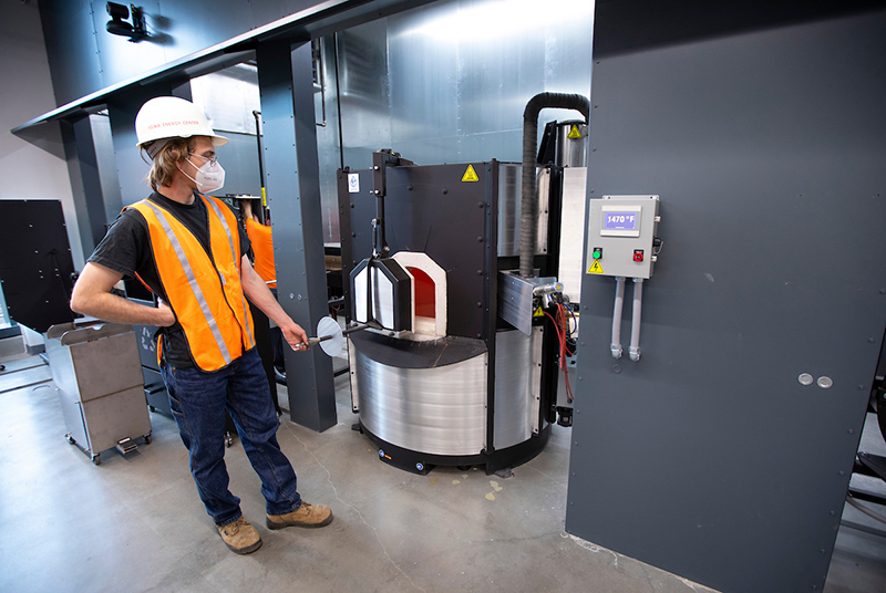 Devon Schuler preps a furnace in the Gaffer's Guild space at the