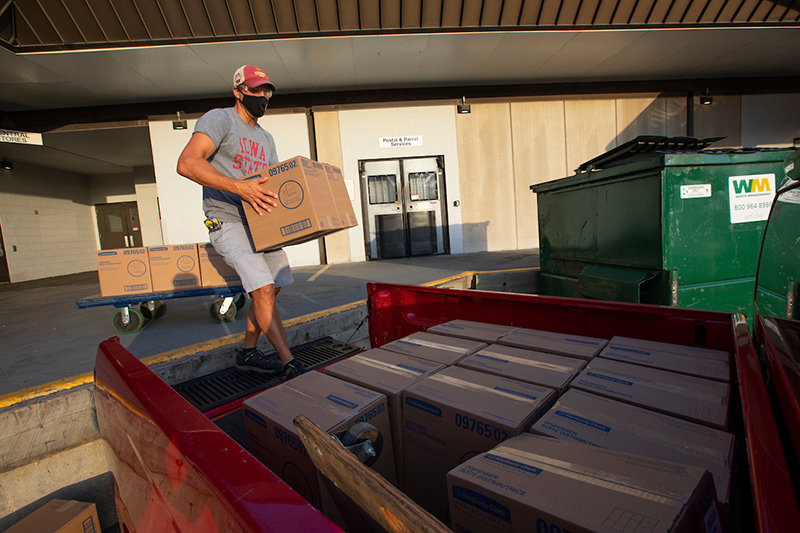 Justin Abbott loads dispensers into his truck