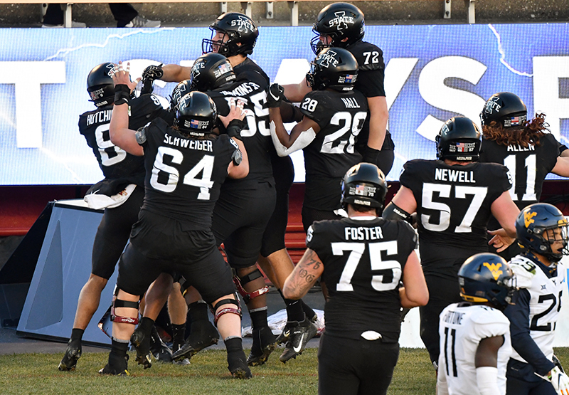 Football players celebrate a touchdown