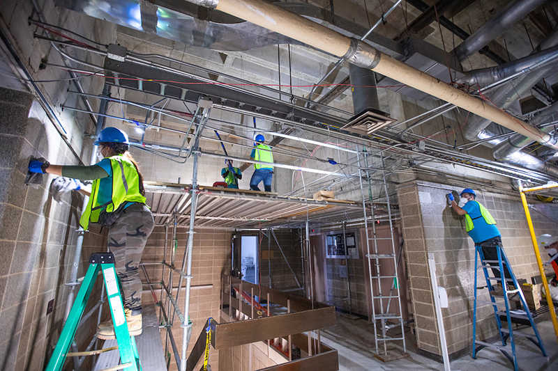 Crews clean walls and above the ceiling line on first floor Ross