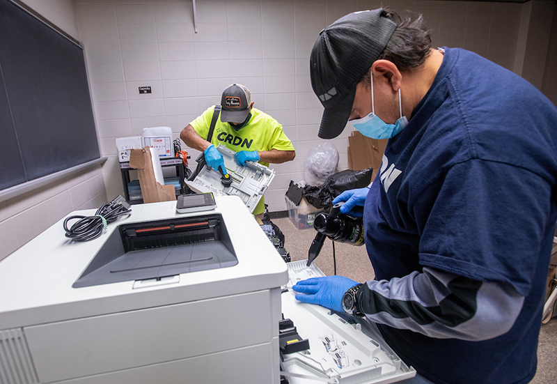 Specialists clean fire soot from printers