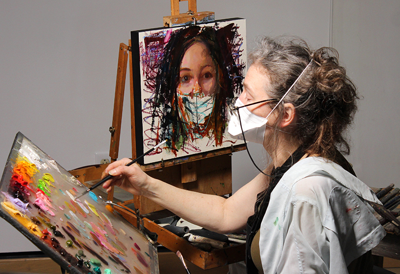 Artist Rose Frantzen works on a student portrait