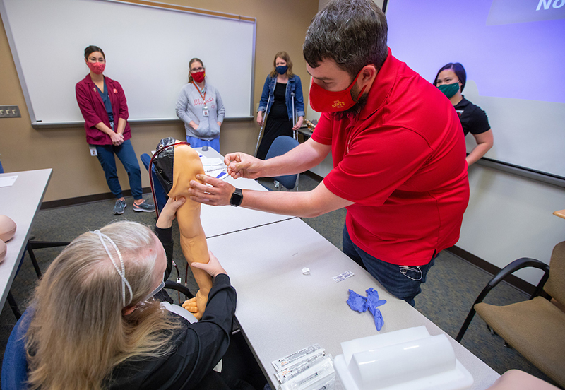 Justin Brown practices with a vaccination needle