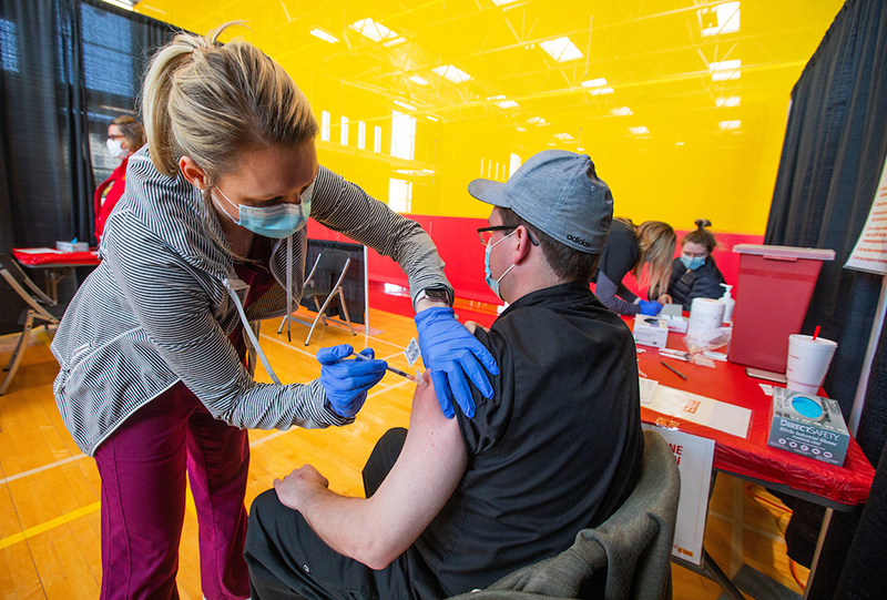 Nurse Kori Grooms administers a COVID-19 vaccine