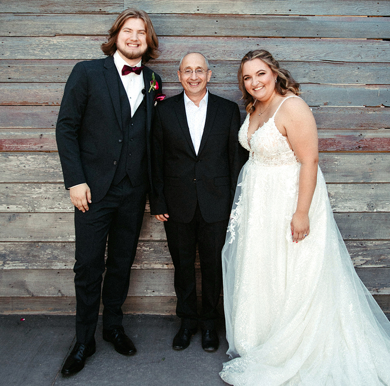 Officiant Alan Constant with the bride and groom
