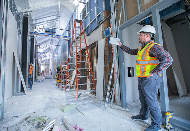 construction manager explains progress on renovation