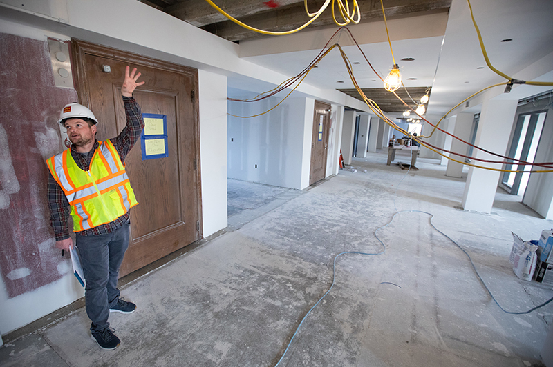 construction manager explains progress on renovation