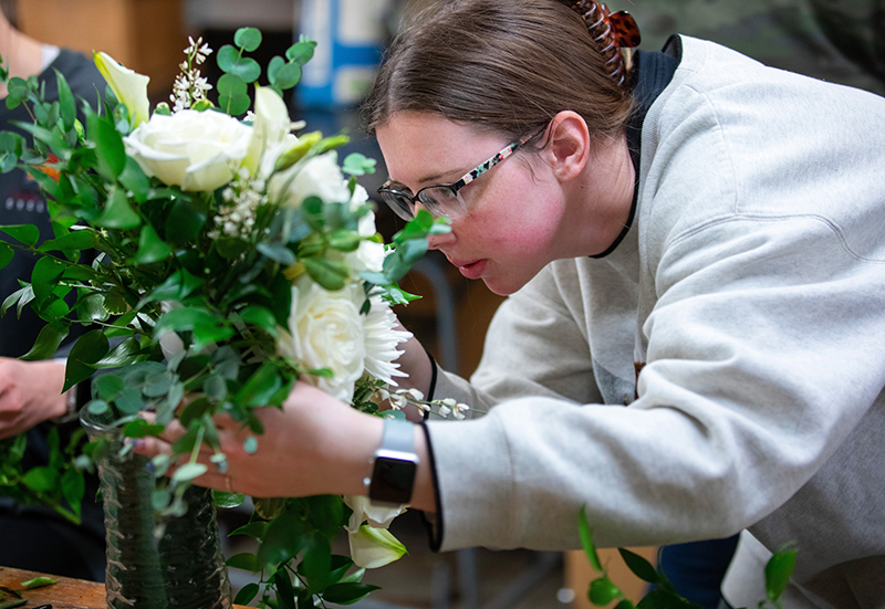 Emily Saeugling works on flower bouquet