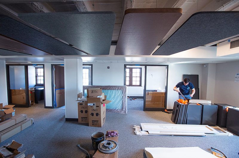 Male employee assembles file cabinets