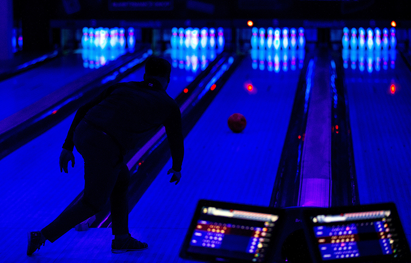 Kyle Martin bowls in black light