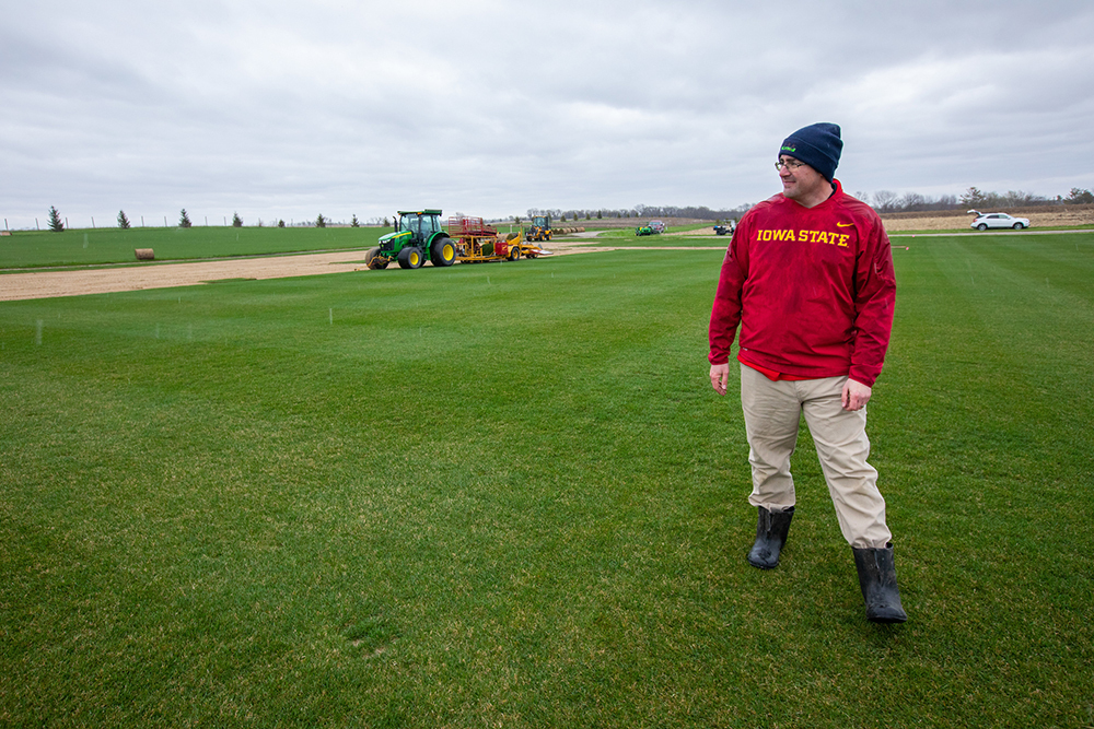 Adam Thoms on the sod field before it's cut