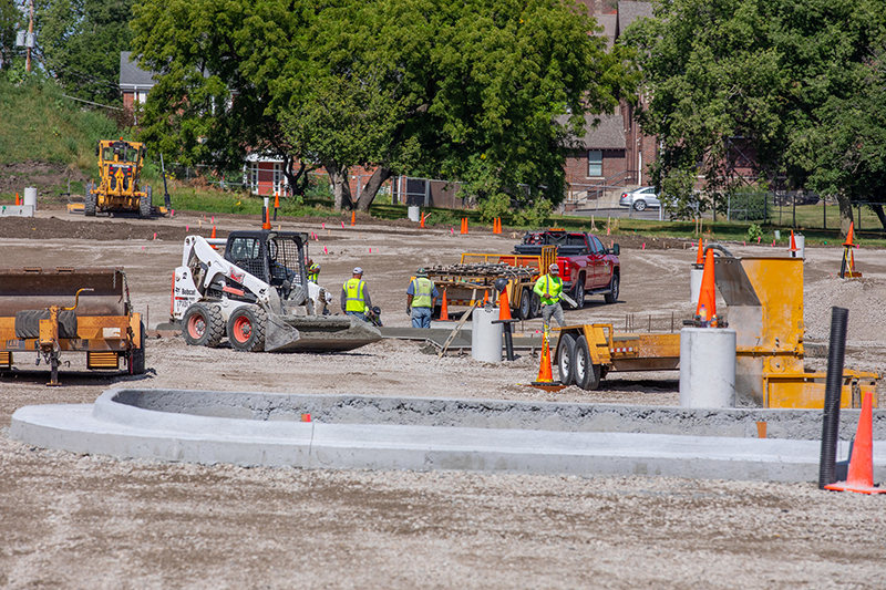 Crew pouring curbs for new parking lot