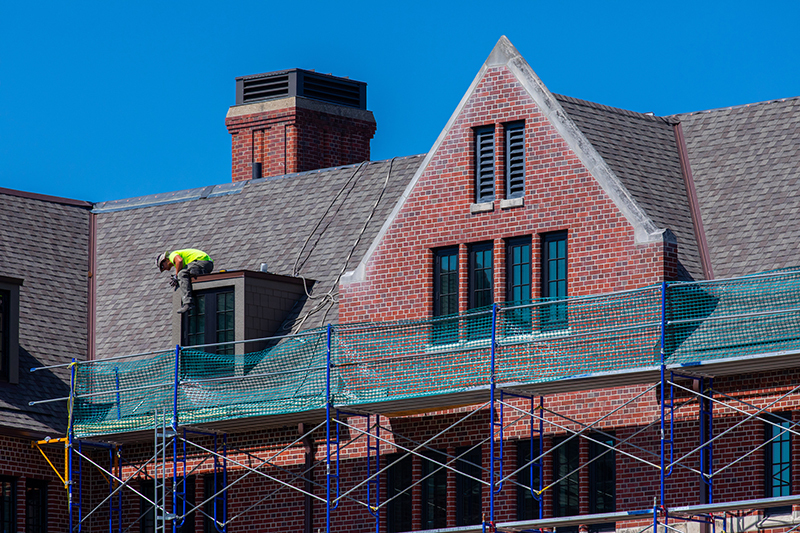 Roofer works on a Friley Hall dormer