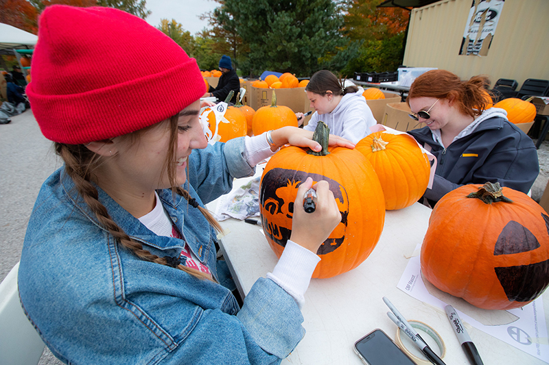 Amy Taylor stencils a pumpkin