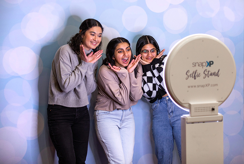 Three female students pose for a photo