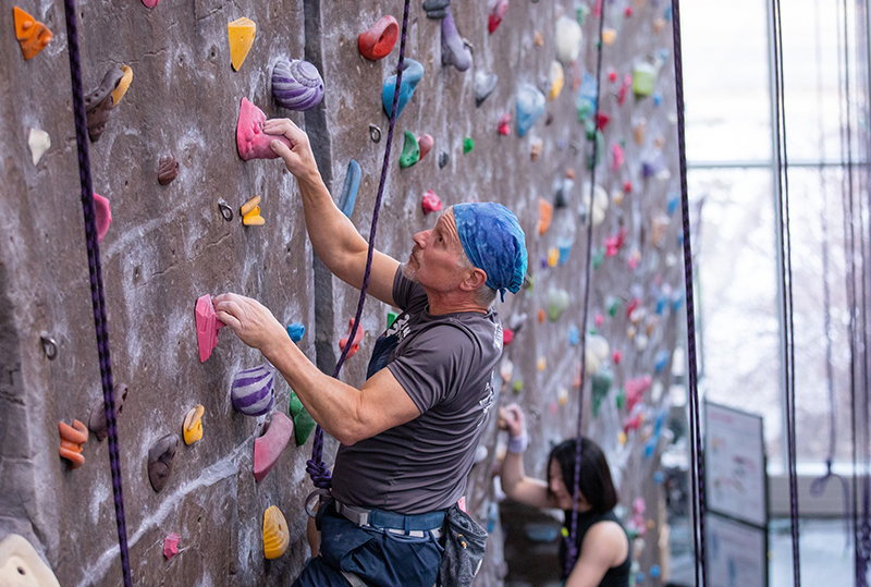 Glenn Wiedenhoeft ascends the State Gym climbing wall