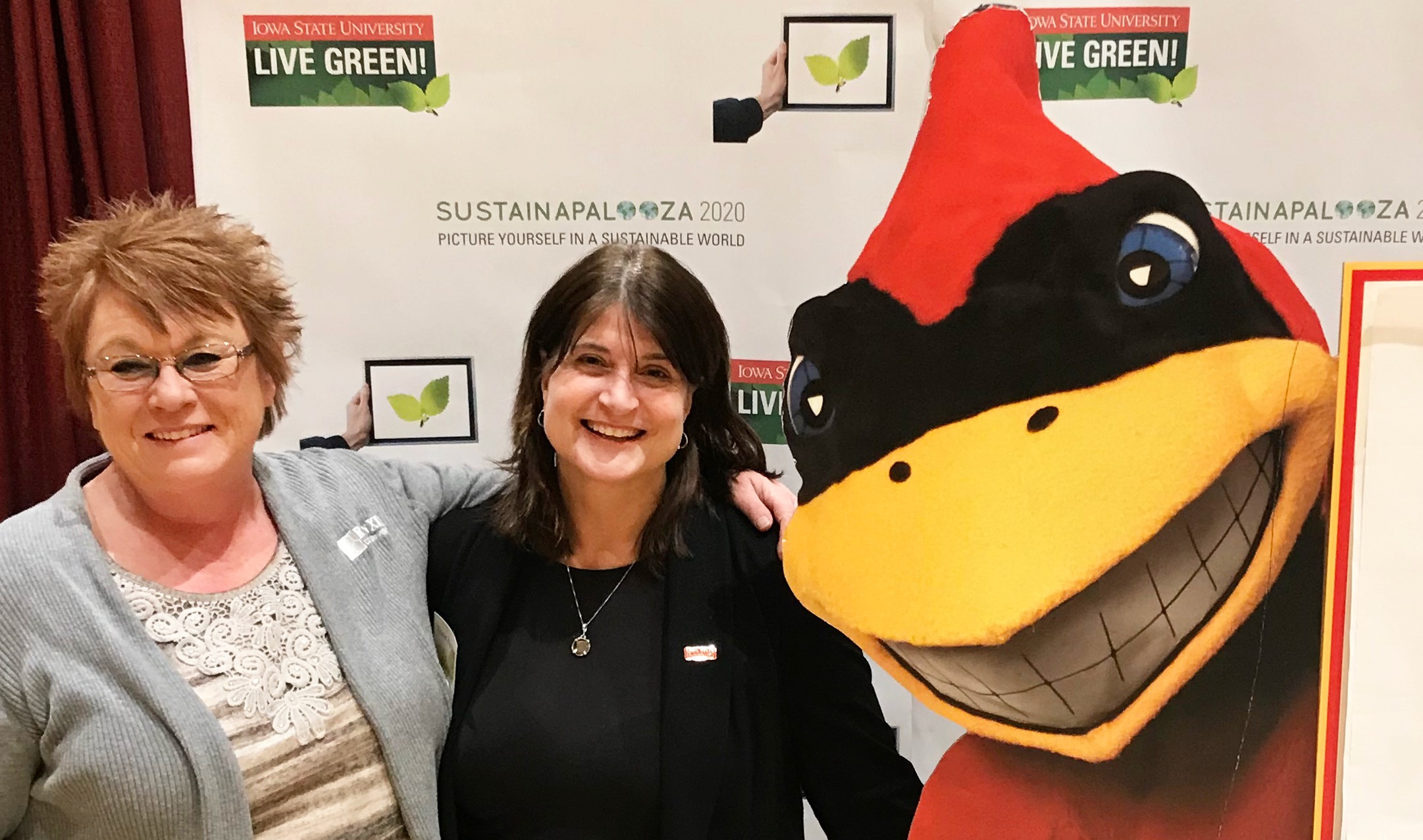 Shelly Codner and Merry Rankin smile with Cy at Sustainapalooza 