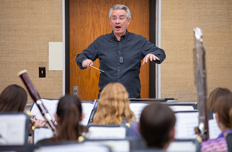 Mike Golemo directs a student band rehearsal