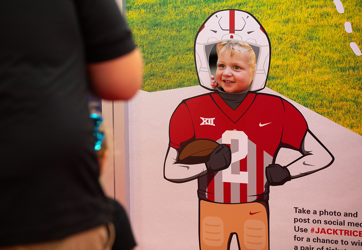 Child's head appears in photo cutout of a football player