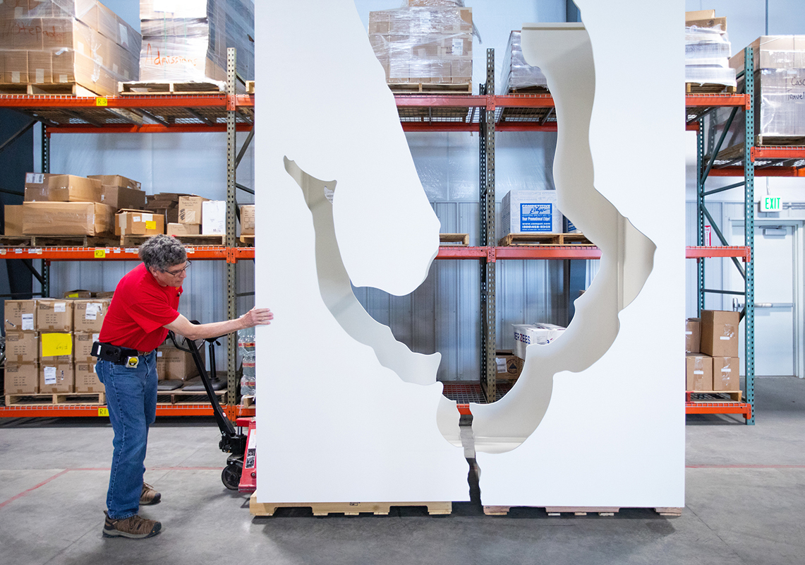 Carpenter Randy Fiscus moves sculpture model for storage