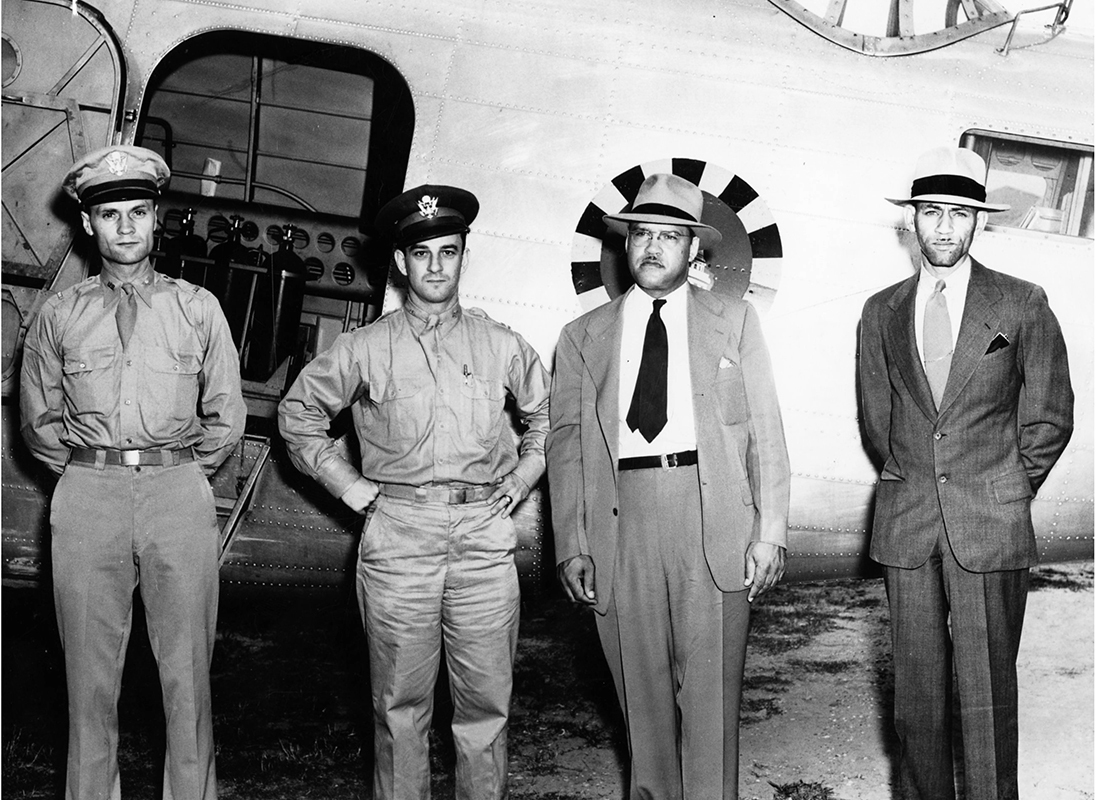 Frederick Patterson and 3 men pose with military plane