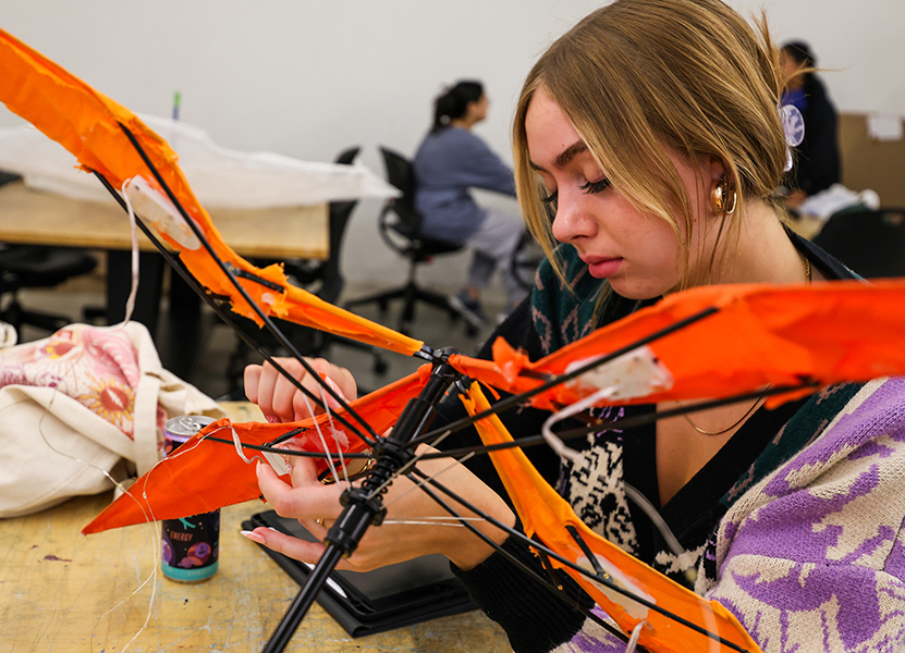 female students assembles orange propeller