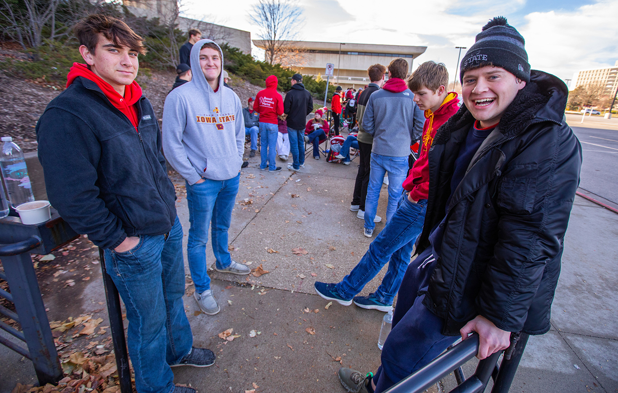 Four male students at front of line outside Hilton Coliseum