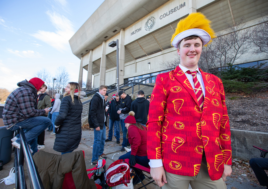 Student in red/gold Cyclone sport jacket in a line outside Hilto