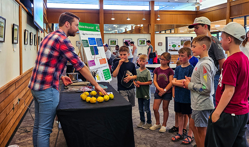 Male with beard explains lemons wired for energy to young group