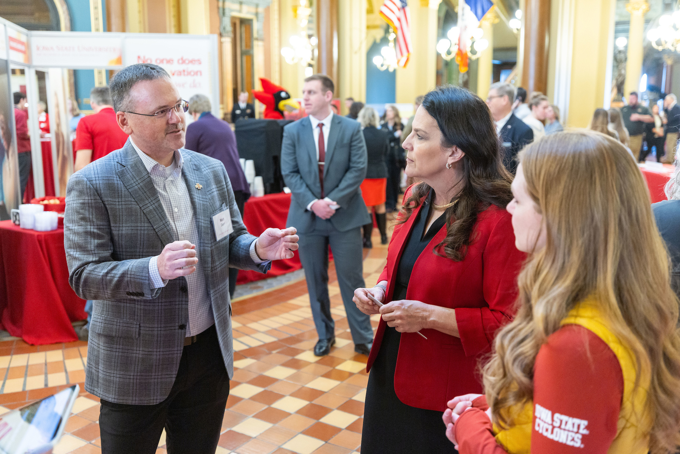 man and two women talk in the capitol rotunda